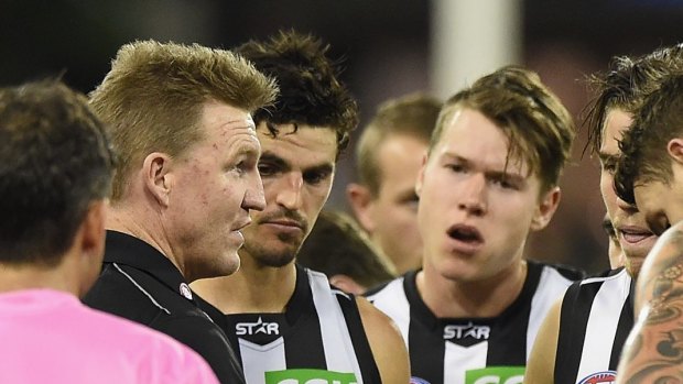 GOLD COAST, AUSTRALIA - MAY 23:  Magpies coach Nathan Buckley speaks to his players during the round eight AFL match between the Gold Coast Suns and the Collingwood Magpies at Metricon Stadium on May 23, 2015 in Gold Coast, Australia.  (Photo by Matt Roberts/Getty Images)