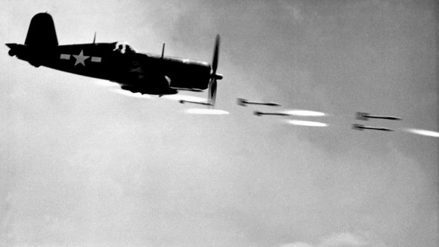 One of David Douglas Duncan photos of a Marine Corsair fighter firing rockets at a Japanese stronghold on Okinawa in June 1945.