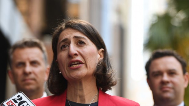 Premier Gladys Berejiklian is flanked by Stuart Ayres and  Andrew Constance while announcing the change in policy on Thursday. 
