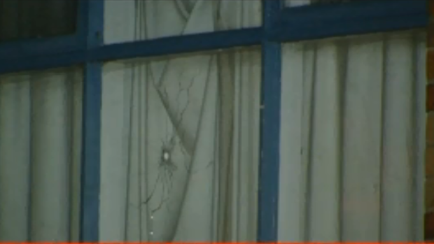 A broken window at the front of the Frankston home, which was the target of a shooting. 