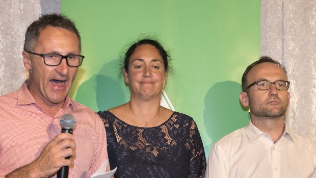 Standing with candidate Alex Bhathal (centre), Greens leader Richard Di Natale (left) concedes defeat in Batman.