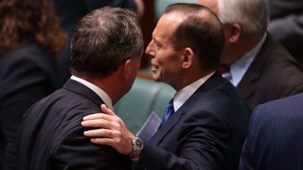 Prime Minister Tony Abbott pats Agriculture minister Barnaby Joyce after question time on Monday.