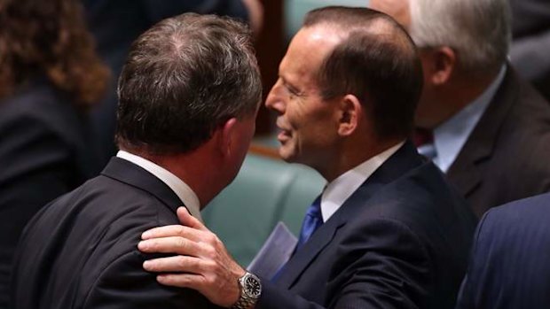 Prime Minister Tony Abbott pats Agriculture minister Barnaby Joyce after question time on Monday.