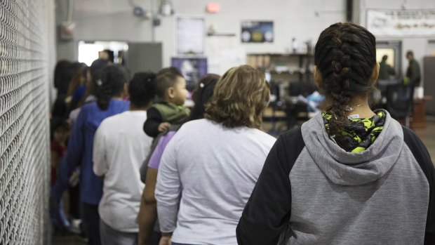 Teens who've been taken into custody related to cases of illegal entry into the United States, stand in line at a facility in McAllen, Texas.