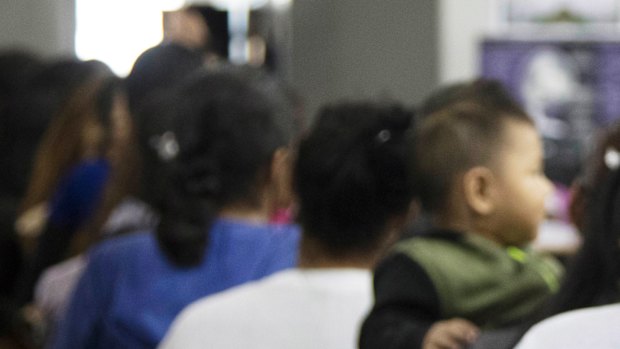 Teens who have been taken into custody related to cases of illegal entry into the United States, stand in line at a facility in McAllen, Texas.