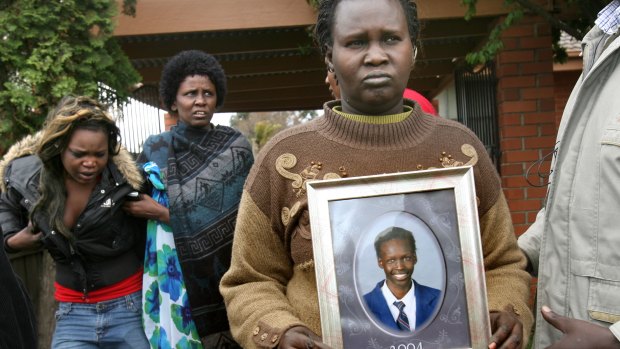 A photo of  Liep Gony is held by his mother Martha Ojulo.