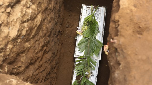 The coffin containing the body of 2-year-old Daryeli Velazquez Raude, one of the six Velazquez who died in a blaze after armed assailants set fire to their house. 