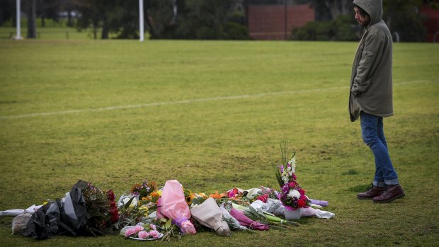 Dylan Scolyer, a friend of Eurydice Dixon, pays tribute to her at the Princes Park on Friday morning. 