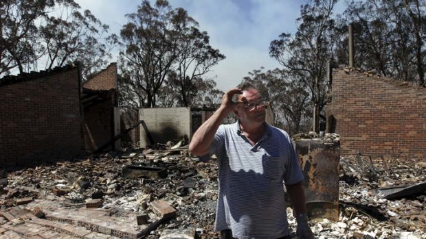 Photograph shows Laurie Eades standing in the ruins of his Mt Victoria home, which was raised in Thursday's firestorm. Laurie was a collector of antique artefacts and was able to salvage some Byzantine coins, silver earrings and an ancient Greek jug.