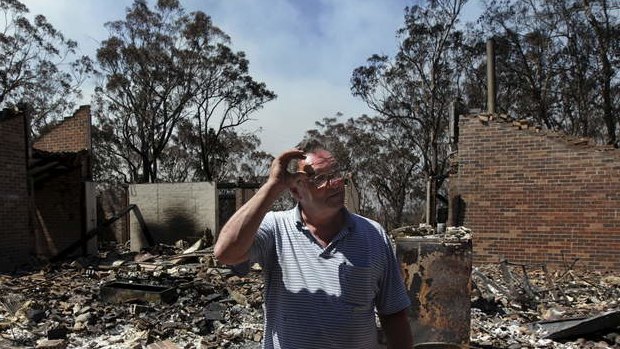 Photograph shows Laurie Eades standing in the ruins of his Mt Victoria home, which was raised in Thursday's firestorm. Laurie was a collector of antique artefacts and was able to salvage some Byzantine coins, silver earrings and an ancient Greek jug.