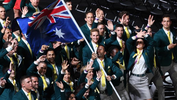 Flag bearer Mark Knowles leads the Australian team at the Commonwealth Games opening ceremony.