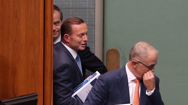 Prime Minister Tony Abbott and Communications Minister Malcolm Turnbull pass Opposition leader Bill Shorten behind the Speaker's chair during a division during question time on Thursday.