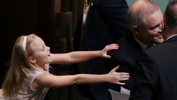 Treasurer Scott Morrison is hugged by his daughter after he gave the budget address on Tuesday.