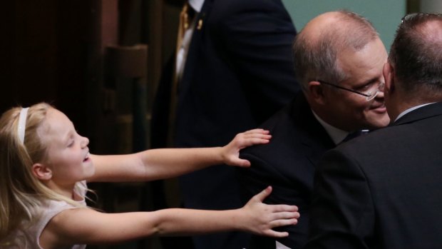 Treasurer Scott Morrison is hugged by his daughter after he gave the budget address on Tuesday.