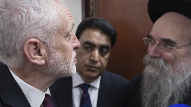 Nothing personal: Labour leader Jeremy Corbyn, left, meets locals at Finsbury Park Mosque in north London, after an incident where where a van struck pedestrians, in London, in June.