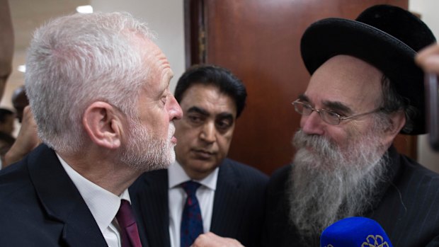 Nothing personal: Labour leader Jeremy Corbyn, left, meets locals at Finsbury Park Mosque in north London, after an incident where where a van struck pedestrians, in London, in June.