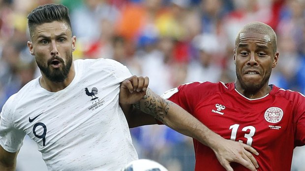 A game to forget: France's Olivier Giroud, left, and Denmark's Mathias Jorgensen challenge for the ball. 