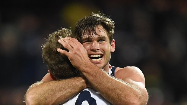 Tom Hawkins hugs Zach Tuohy after his match-winning goal.