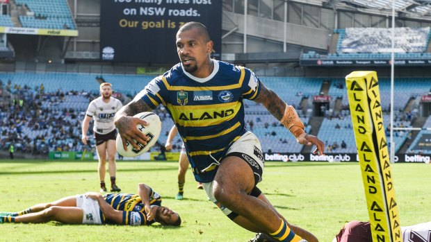 Carnage: Manu Ma'u leaves bodies in his wake as he crosses for Parramatta.