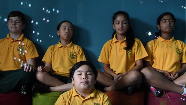 In the moment: Haris Mahmutovic, Calvin Lai, Juliet Gong, Jyonbi Acharya and Nitya Agarwal of Homebush West Public School take part in mindfulness classes. 