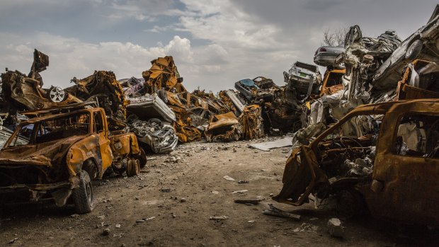 Cars destroyed during the fight for Mosul are piled up on the outskirts of the Old City in the west.
