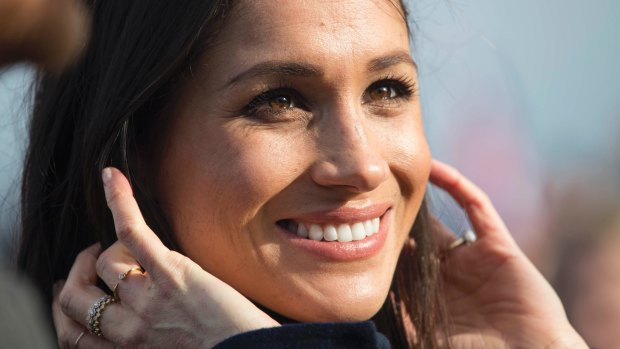 Meghan Markle looks on during a walkabout with Britain's Prince Harry on the esplanade at Edinburgh Castle,.