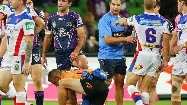 Knights forward Alex McKinnon on the ground after being tackled by the Melbourne Storm. He was stretchered off the field.