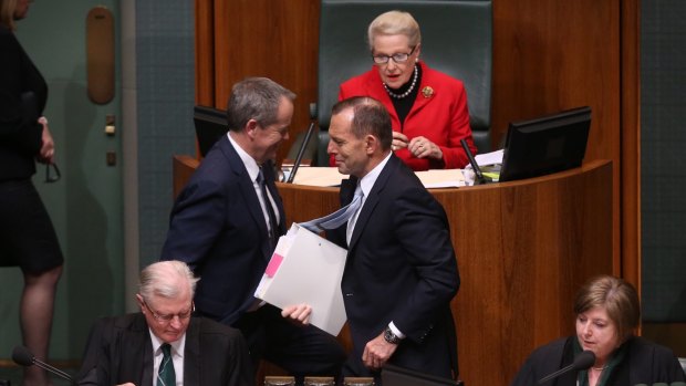 Prime Minister Tony Abbott and Opposition Leader Bill Shorten pass after a divison during question time.