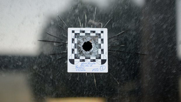 A bullet hole at the front of a police impound yard in Preston. 