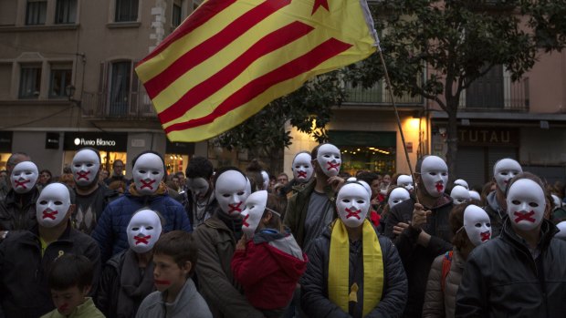 People stand in support of Catalonian politicians in Germany, during a protest in Figures, Spain.