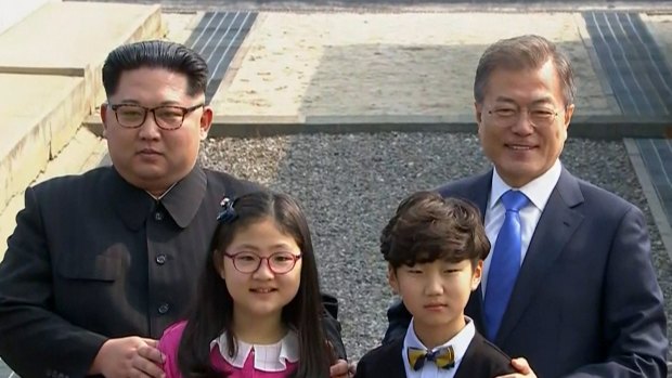 North Korean leader Kim Jong-un, left, and South Korean President Moon Jae-in, right, pose with children as Kim crossed the border into South Korea for their historic face-to-face talks.