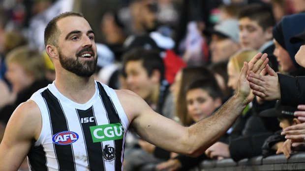 Milestone magic: Collingwood fans congratulate Steele Sidebottom after his 200th game.
