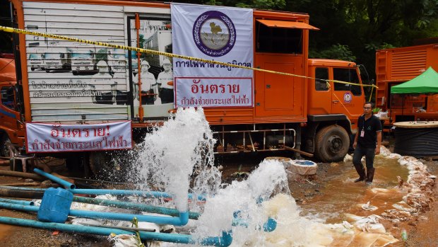 Men from the Electricity Generating Authority of Thailand overseeing the pumping of water from Tham Luang Cave.