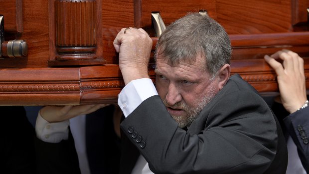 Greg Hughes carries his son's casket.