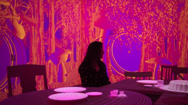 An immersive installation using projections recreates the Mad Hatter's tea party.