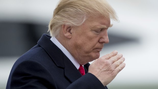 US President Donald Trump saluting.