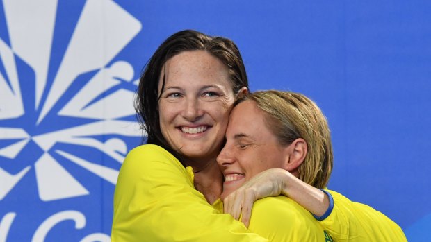 Silver medalist Cate Campbell (left) hugs her sister, gold medalist Bronte Campbell, during the medal ceremony for the Women's 100m Freestyle.