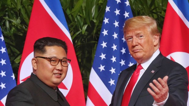 US President Donald Trump gestures toward the media with North Korea leader Kim Jong-un.