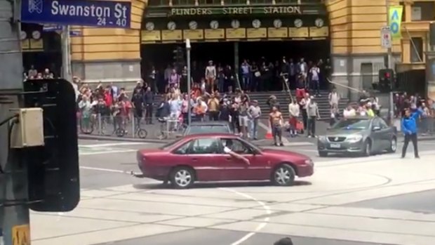 A car drives in circles outside Flinders Street Station shortly before pedestrians were hit.