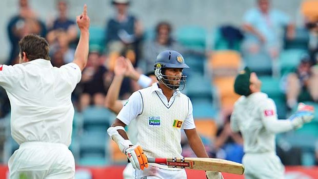 Sri Lanka's batsman Dimuth Karunaratne is dismissed by Australian quick Ben Hilfenhaus.