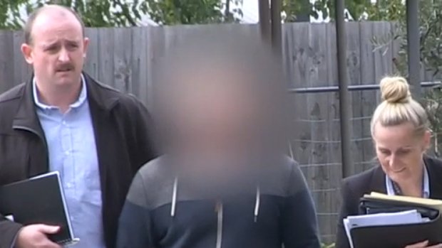 Police arrest a man during a child pornography raid in Melbourne.