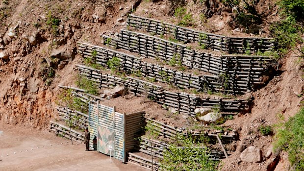 A guard stands at the doors of the west tunnel at North Korea's nuclear test site shortly before the tunnel was blown up during a media tour.