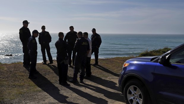 California Highway Patrol officers and deputy sheriffs gather after a search for three missing children at the site where the bodies of Jennifer and Sarah Hart and three of their adopted children were recovered two days earlier.