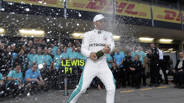 Mercedes driver Lewis Hamilton, of Britain, celebrates his unlikely win in the Azerbaijan Formula One Grand Prix.