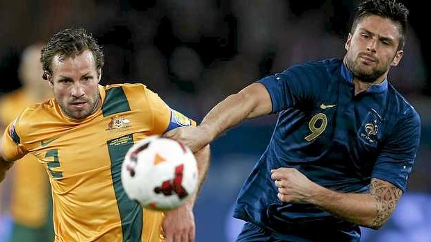 Then-skipper Lucas Neill  tangles with Olivier Giroud during the fateful 2013 friendly against France.