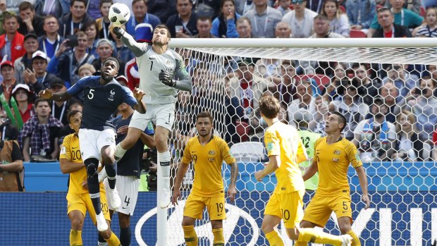 First choice: Mat Ryan punches the ball against France.
