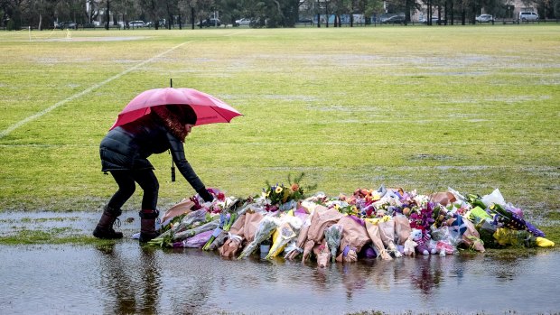 Flowers rest at the site where Eurydice Dixon's body was found in Melbourne on Sunday 17 June 2018. 