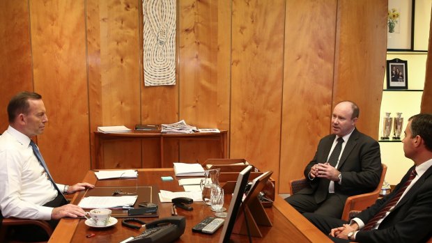 Prime Minister Tony Abbott meets with Justice Minister Michael Keenan and Commonwealth Counter-Terrorism Coordinator Greg Moriarty, in his office at Parliament House on Monday.