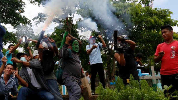 Masked protesters shoot homemade weapons during the burial of Jorge Zepeda in Monimbo, Nicaragua, Thursday, June 7, 2018. Zepeda died of gunshot wounds during June 6 protests against the government of President Daniel Ortega. 