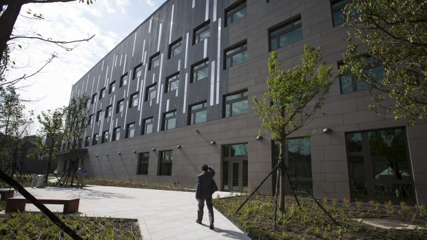 A man walks through the American Institute in Taiwan's new complex in Taipei, Taiwan.